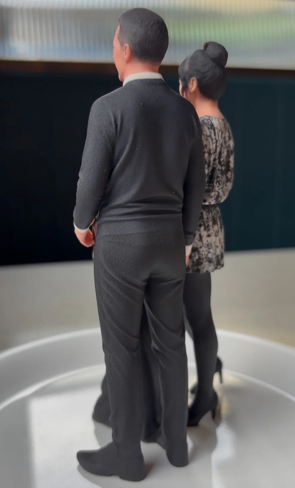 Rear angle of a custom 3D printed family figurine capturing the pose from the original photo