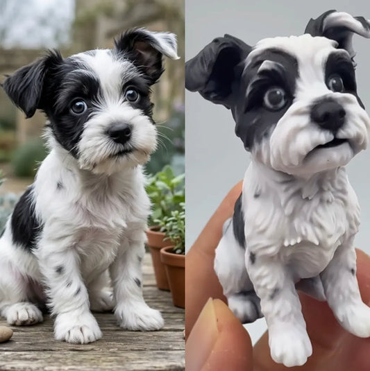 Two custom 3D dog figurines of black and white puppies held in hand outdoors
