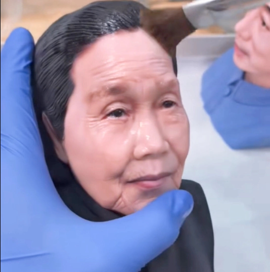 Artisan hand-painting the face of a custom 3D printed elderly woman portrait figurine — 3D Portrait Lab
